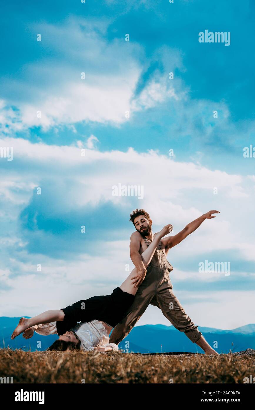 Two athletic young dancers making a performance at mountain peak Stock Photo
