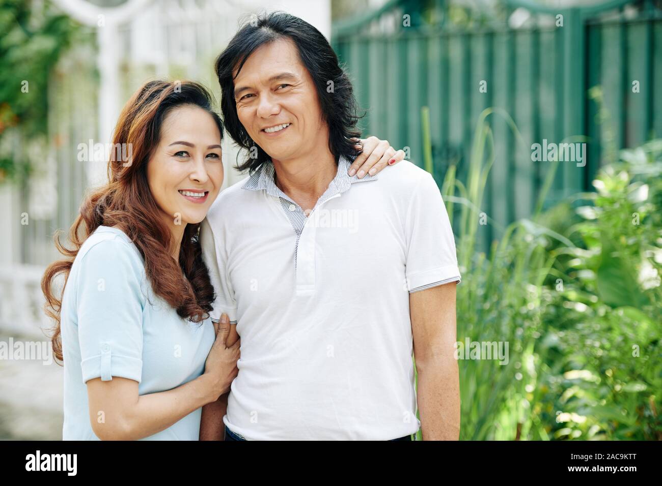 Middle aged asian couple hugging and smiling hi-res stock photography ...
