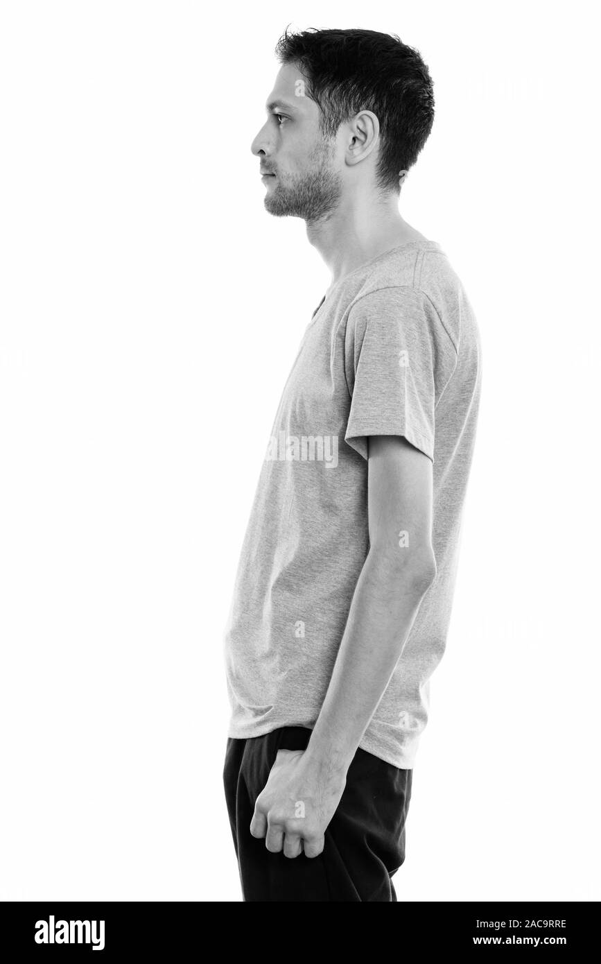 Profile view of young skinny man with beard stubble Stock Photo