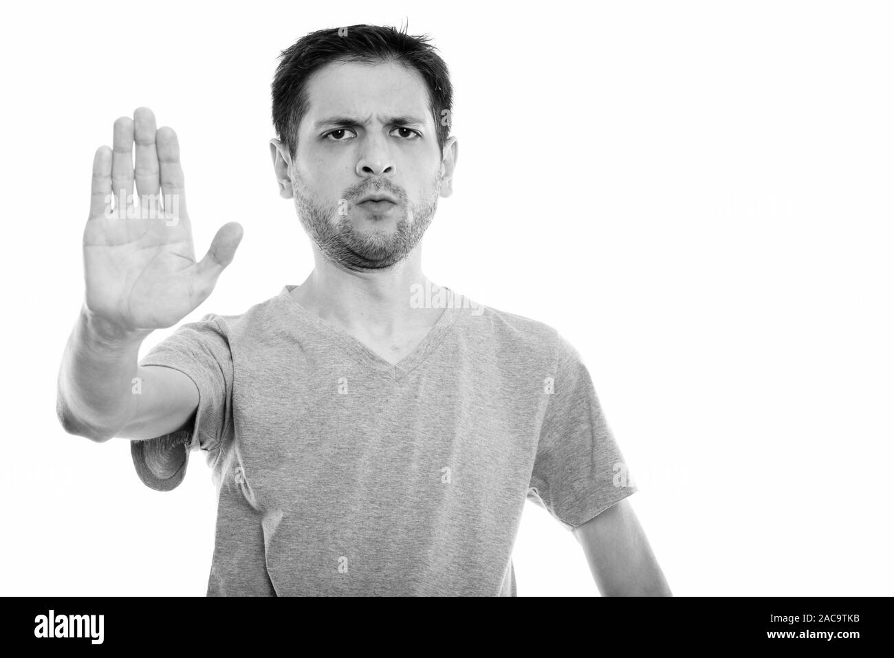 Studio shot of angry young man with stop hand sign Stock Photo