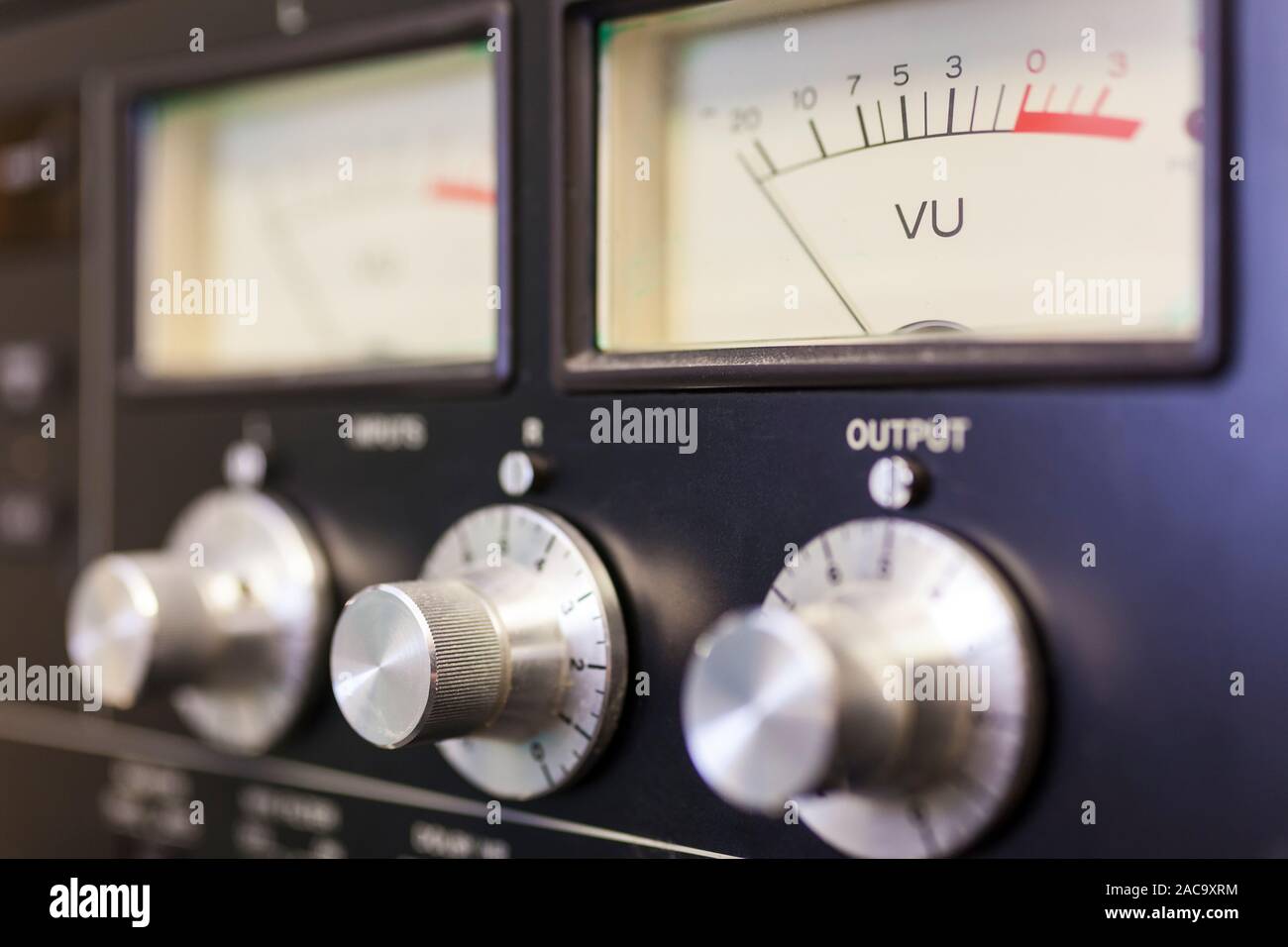 Close up macro photograph of analogue UV sound volume meter and control dials in a recording studio or on a mixing desk Stock Photo