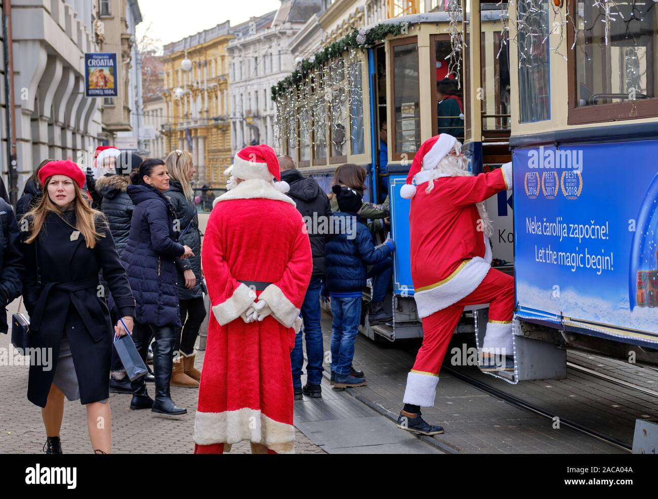 Multiple Santas at the boarding of the Merry Christmas Tram featured at the Advent Market.  Zagreb, Croatia Stock Photo