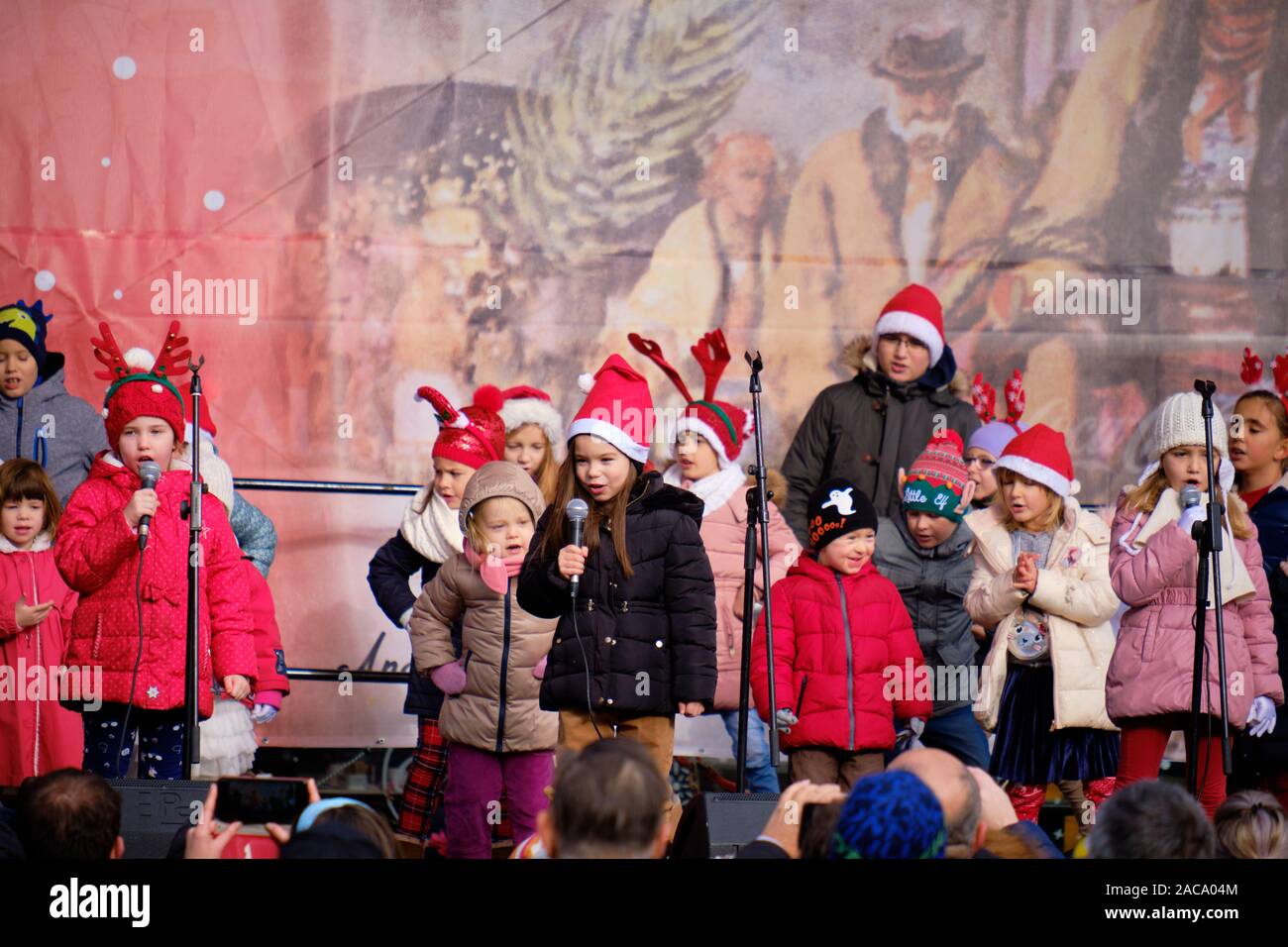 Group of young school kids performing Croatian songs, on centre stage in Zagreb, part of the festivities of the annual Advent Market.  Zagreb, Croatia Stock Photo