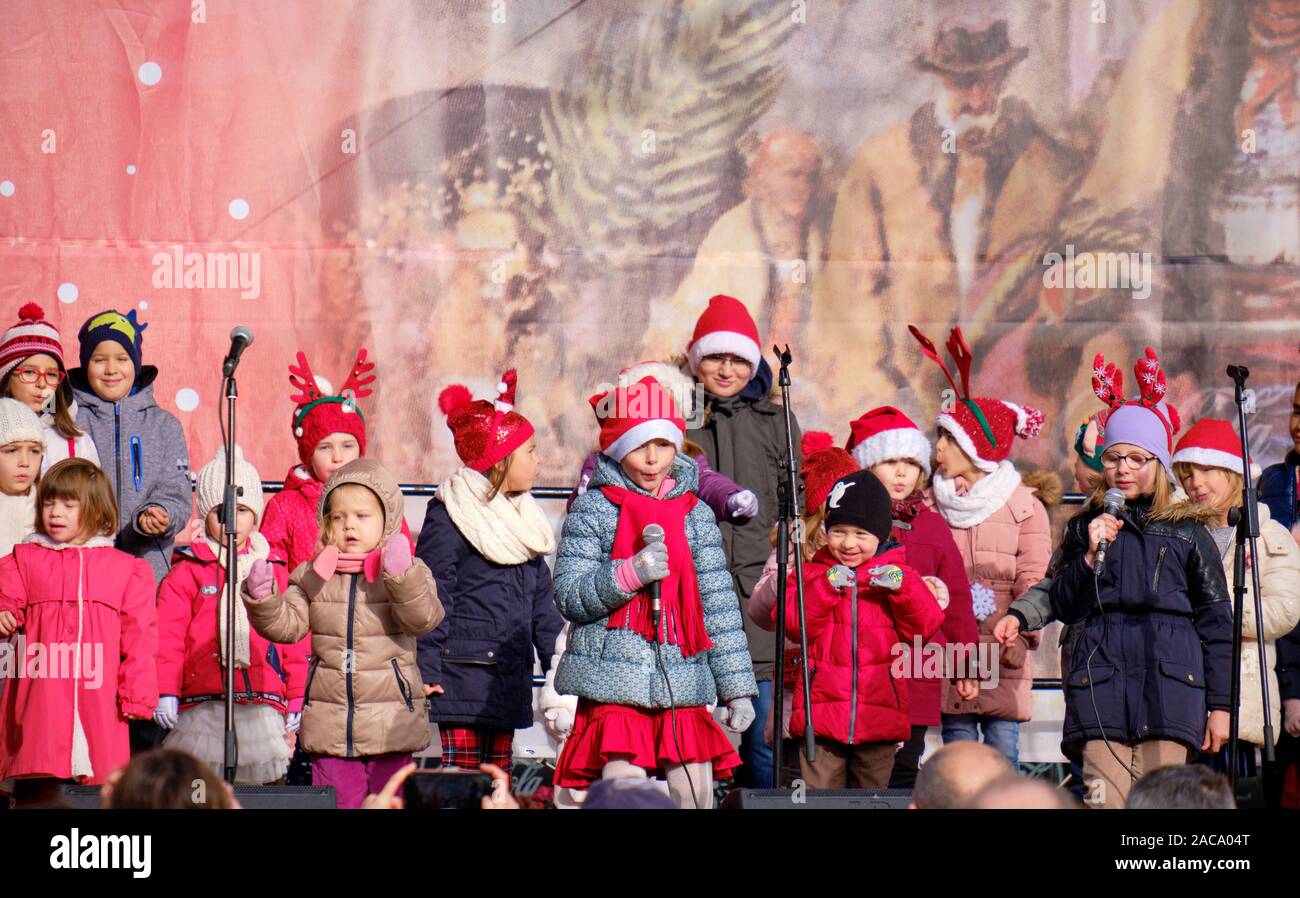 Group of young school kids performing Croatian songs, on centre stage in Zagreb, part of the festivities of the annual Advent Market.  Zagreb, Croatia Stock Photo