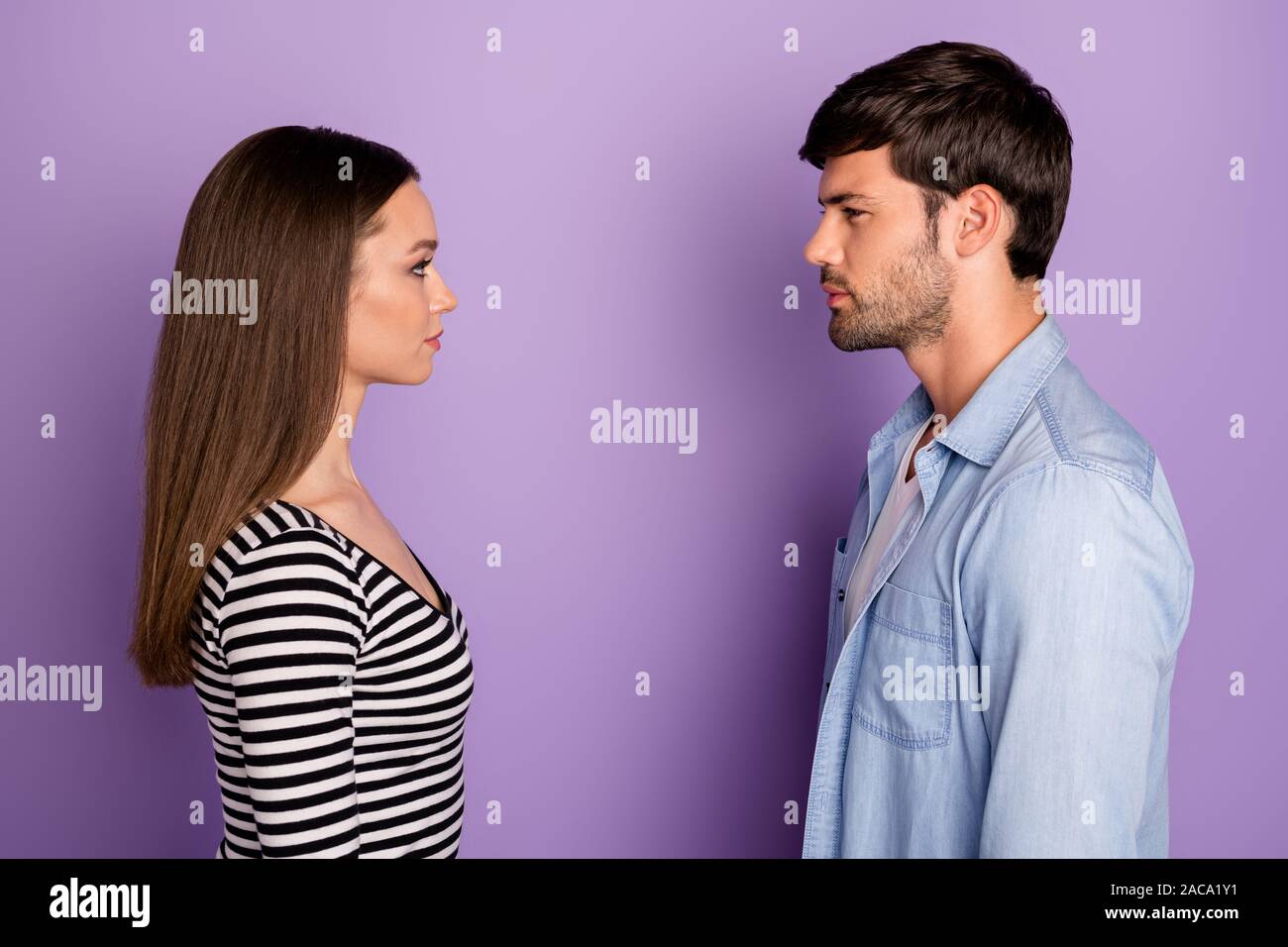 Profile photo of two people couple guy lady standing opposite looking eyes have conflict situation wear stylish casual outfit isolated pastel purple Stock Photo