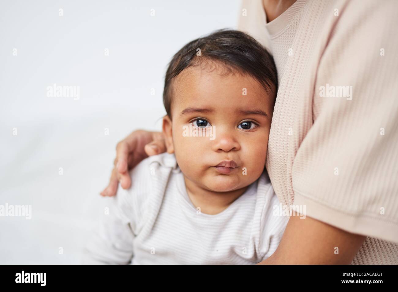Portrait of African baby boy looking at camera while sitting on his