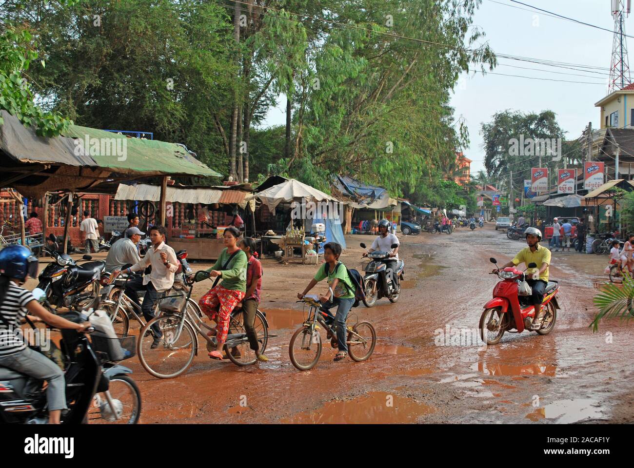 Cambodian cyclists in the rainy season Stock Photo - Alamy
