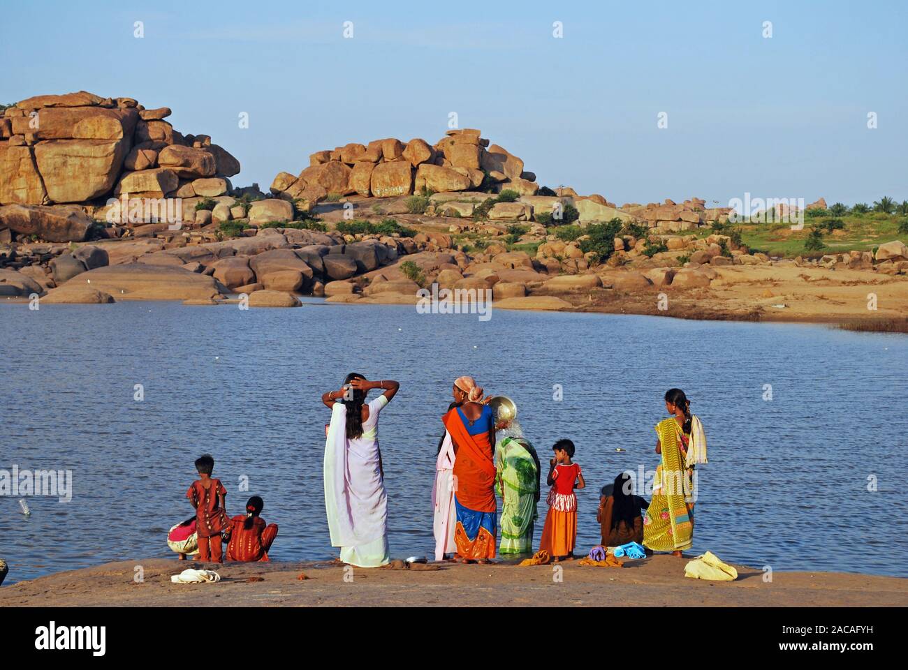 Indian women wash the Tungabhadra River at Hampi, southern India, Asia Stock Photo