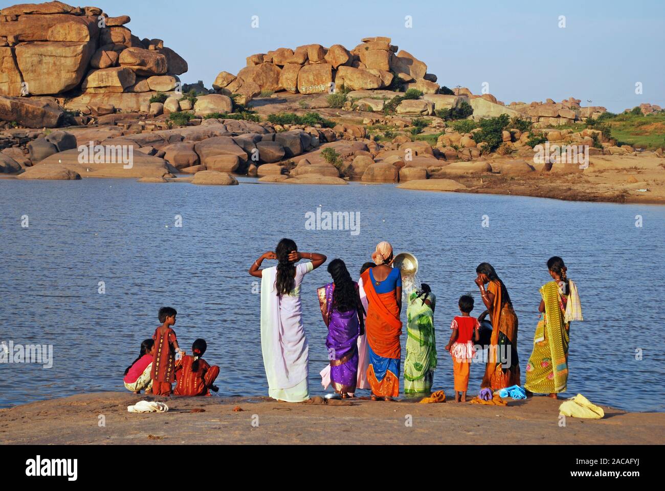Indian women wash the Tungabhadra River at Hampi, southern India, Asia Stock Photo
