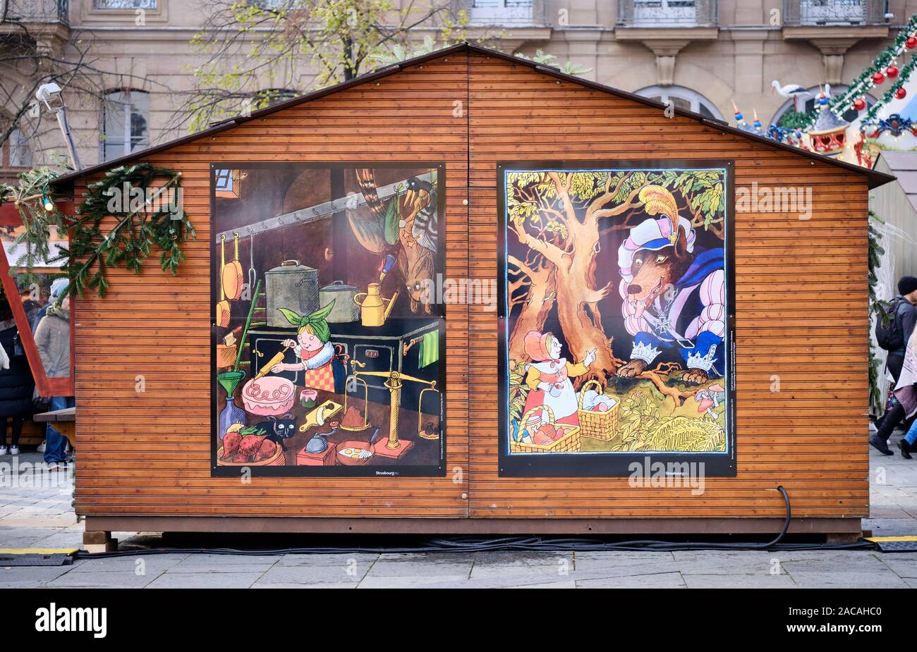 Strasbourg Christmas Market cabin with two prints showing the art of local illustration artist Tomi Ungerer. Stock Photo