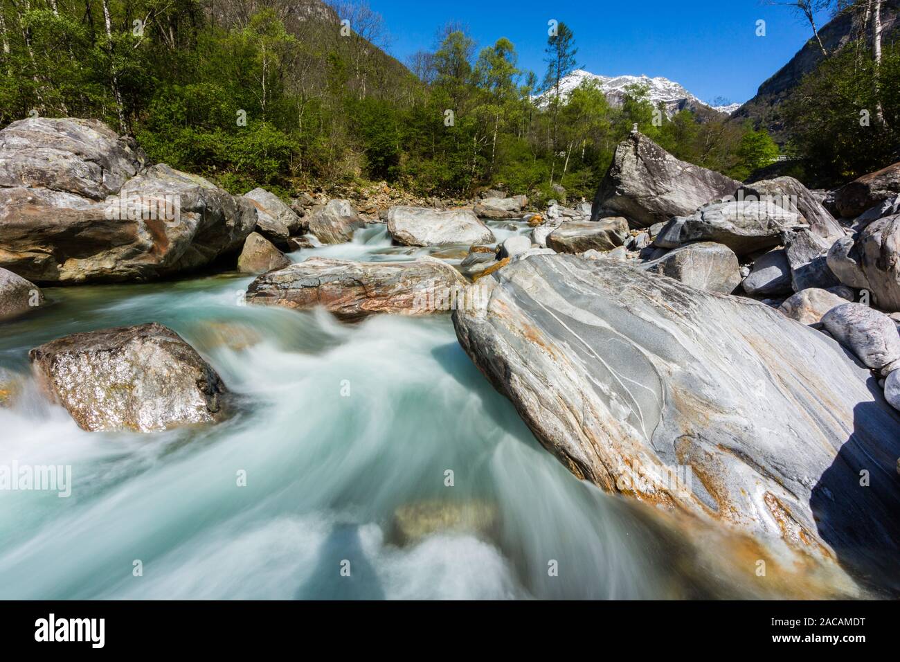 colorful Verzasca river in Ticino in Switzerland in spring, blue sky, sunshine Stock Photo