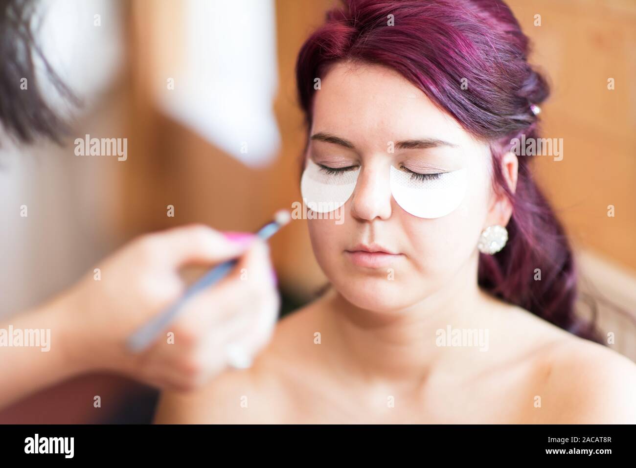 A beautiful bride to be getting ready during bridal prep, preparation hours before the marriage ceremony, excited for the big day ahead Stock Photo