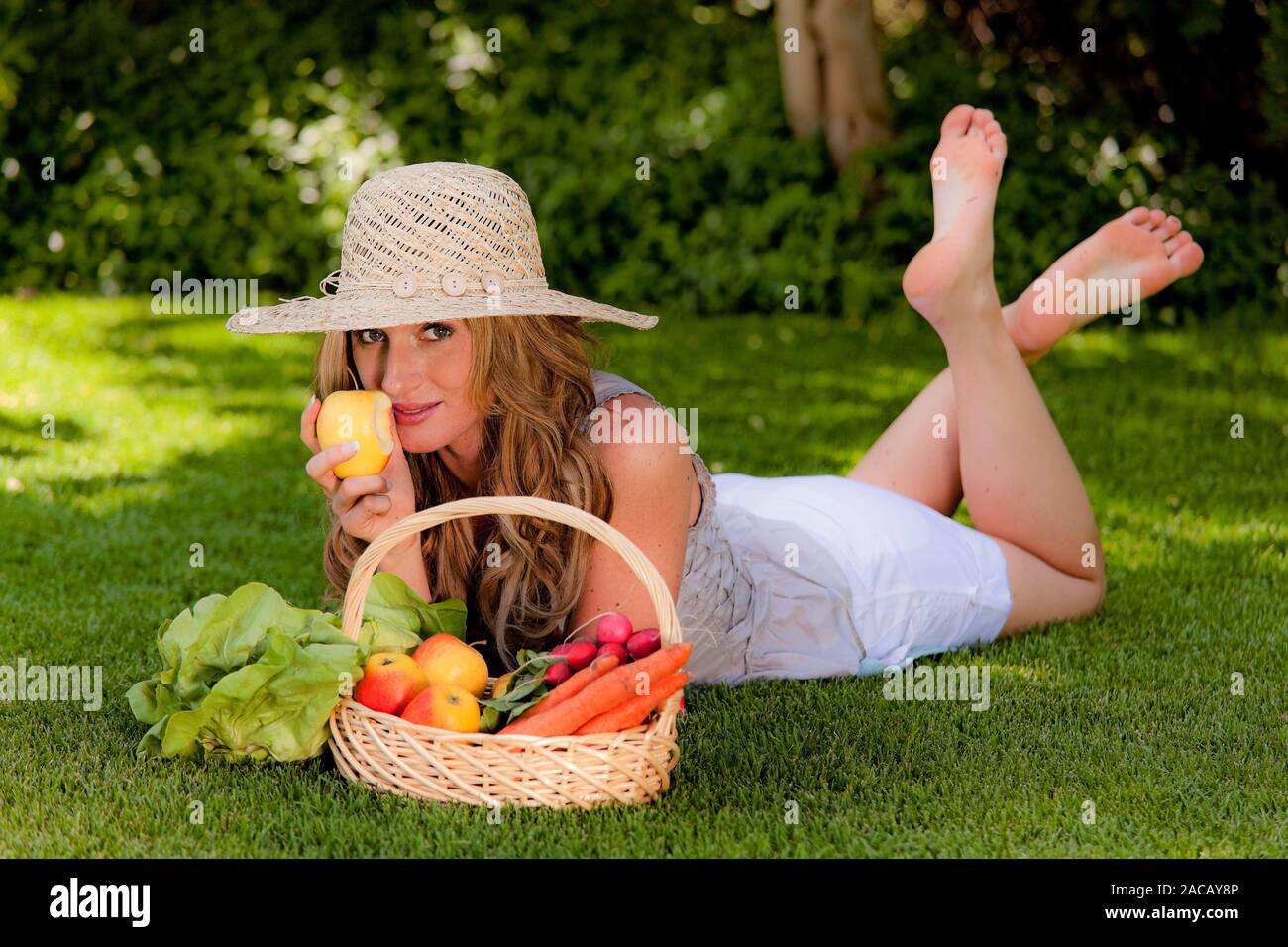 Fruit and vegetables in a basket with a woman Stock Photo - Alamy