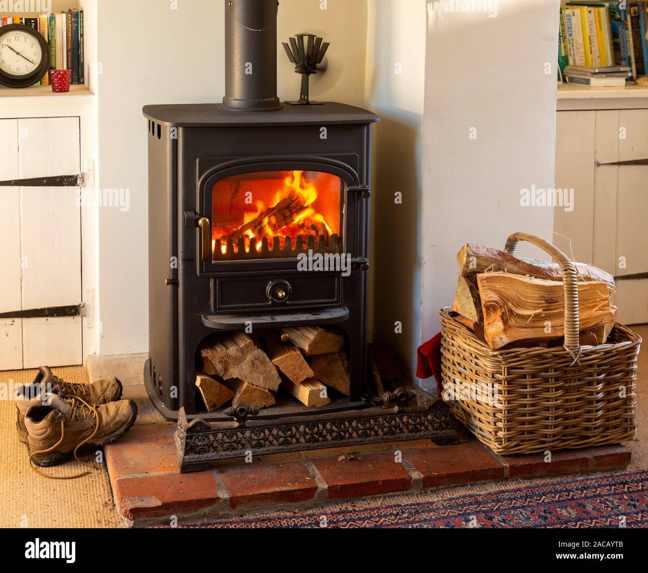 Roaring warm log fire Clearview multi fuel domestic stove burner in living room of home Stock Photo
