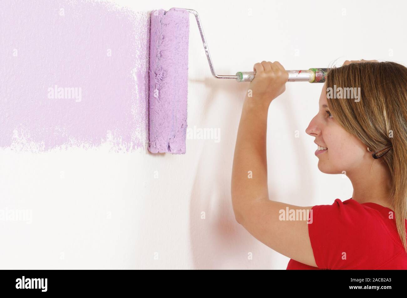 Woman painting a wall hi-res stock photography and images - Alamy
