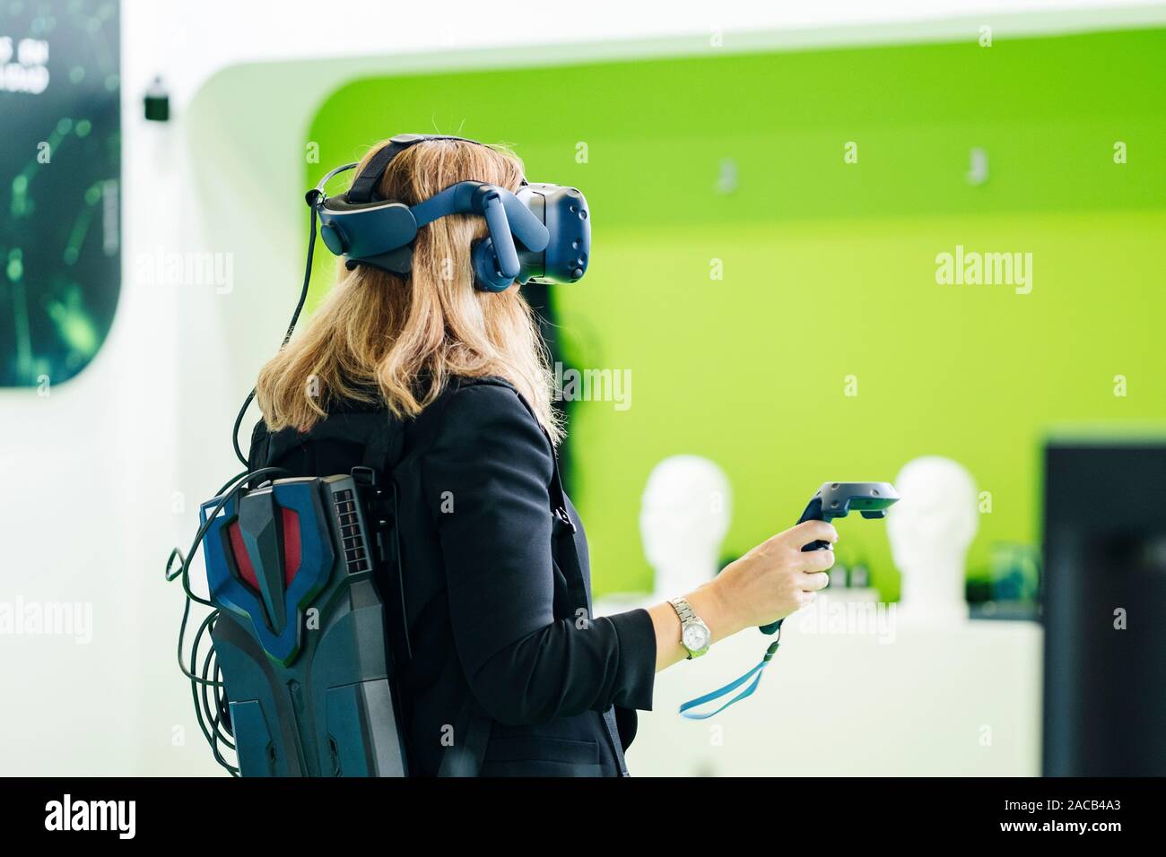 A business woman wears virtual reality glasses with a command at a ...