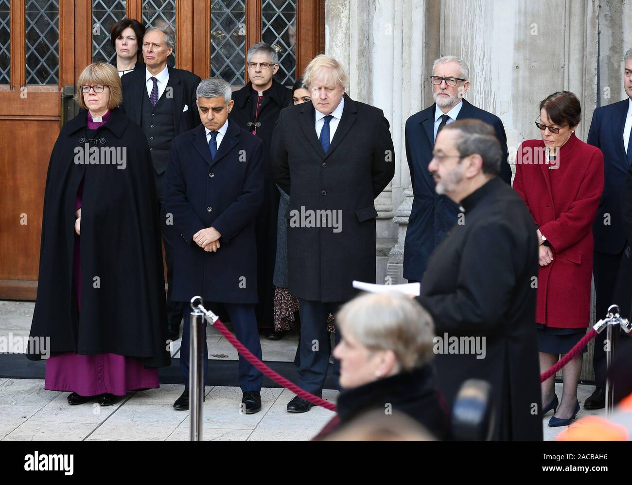 Mayor of London Sadiq Khan (front row 2nd left), Prime Minister Boris Johnson (centre) and Labour leader Jeremy Corbyn (3rd right) take part in a vigil in Guildhall Yard, London, to honour the victims off the London Bridge terror attack, as well as the members of the public and emergency services who risked their lives to help others after a terrorist wearing a fake suicide vest went on a knife rampage killing two people, was shot dead by police on Friday. Stock Photo