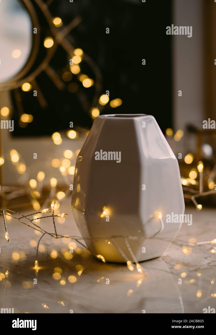 Home Decor Ceramic Vase And String Lights On Marble Table Close