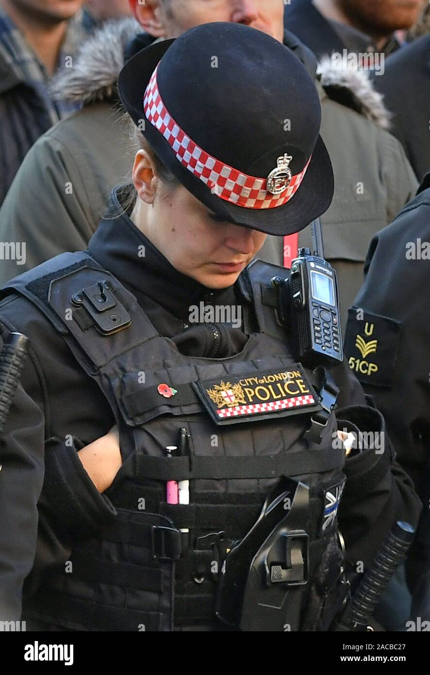 Police officers at a vigil in Guildhall Yard, London, to honour the victims off the London Bridge terror attack, as well as the members of the public and emergency services who risked their lives to help others after a terrorist wearing a fake suicide vest went on a knife rampage killing two people, was shot dead by police on Friday. Stock Photo