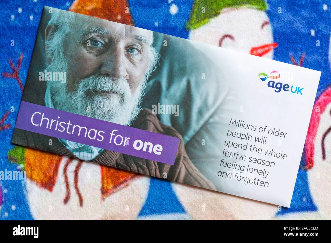 Post on Christmas mat - Christmas for One mail from Age UK, millions of older people will spend the whole festive season feeling lonely and forgotten Stock Photo