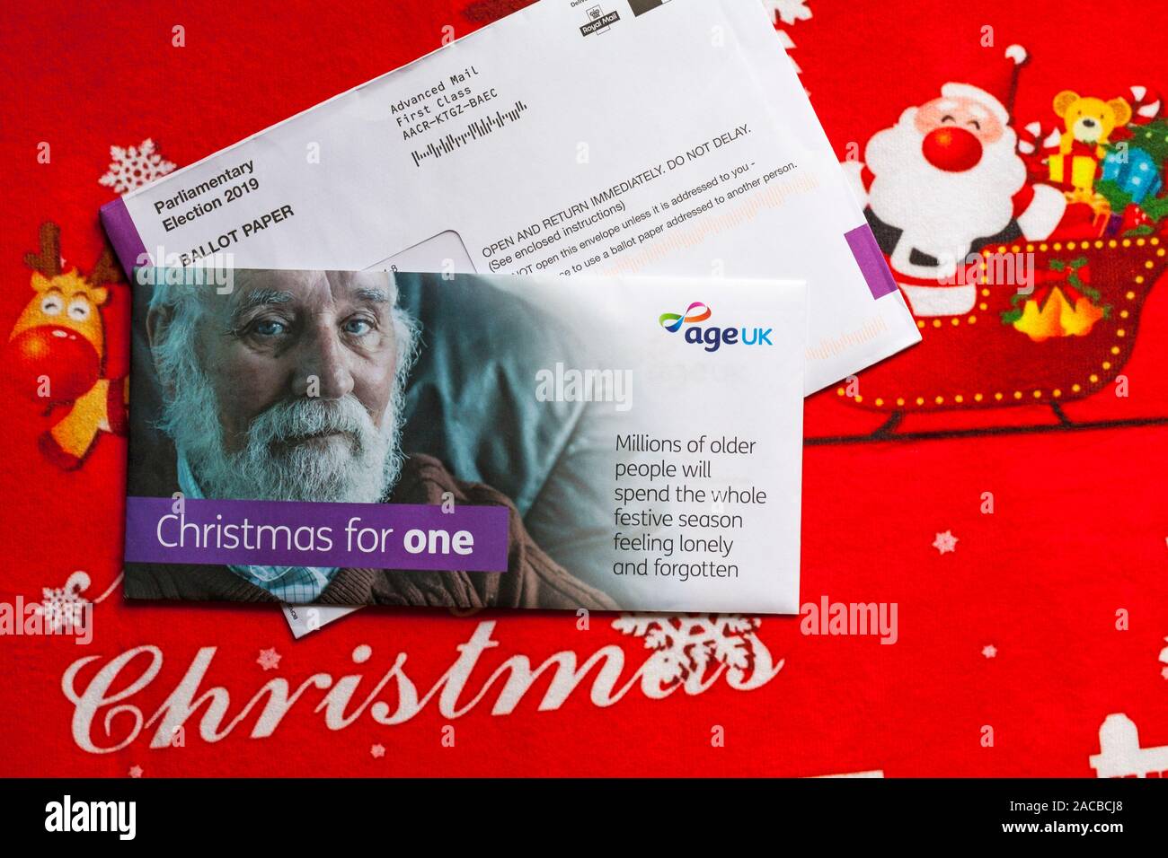 Post on Christmas mat including Parliamentary Election 2019 Ballot Paper for forthcoming general election and Christmas for One mail from Age UK Stock Photo