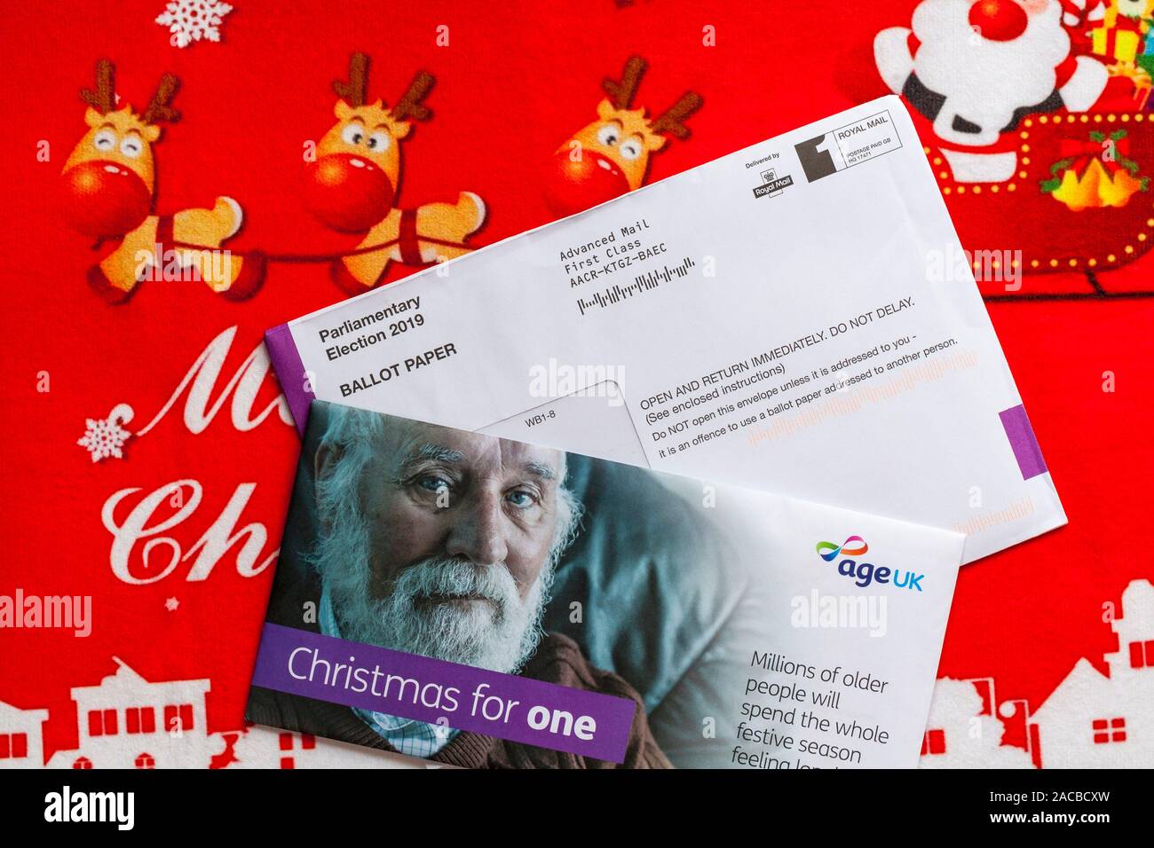 Post on Christmas mat including Parliamentary Election 2019 Ballot Paper for forthcoming general election and Christmas for One mail from Age UK Stock Photo