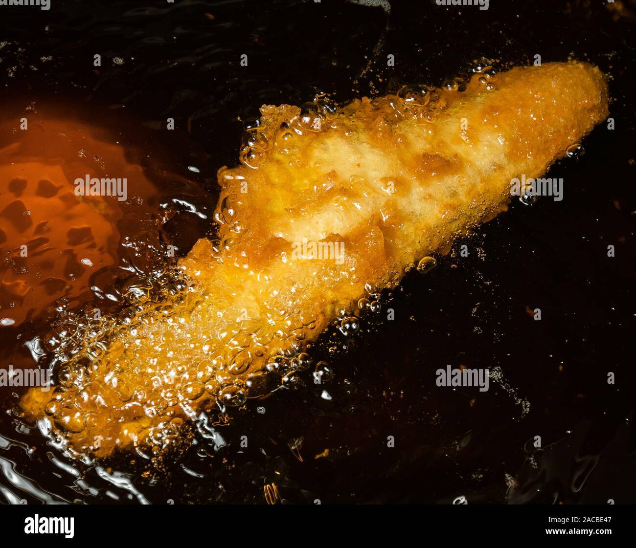 Fish cooking in a deep fat fryer in a fish and chip shop in the United