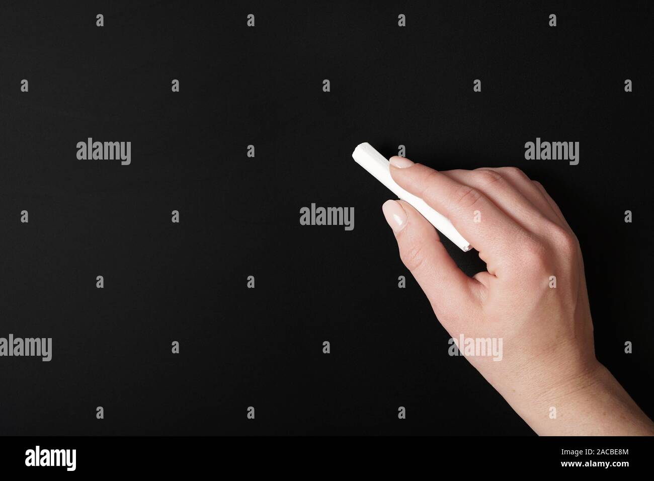 hand writing with chalk on blank chalkboard background Stock Photo