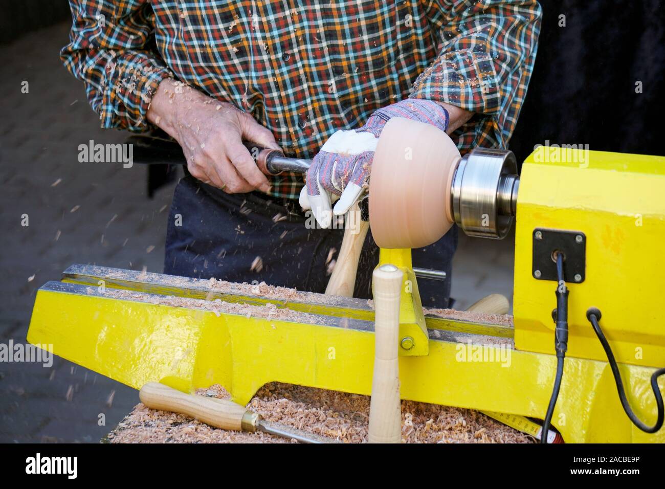unrecognizable craftsman turning wood with lathe, woodworking craftsmanship Stock Photo