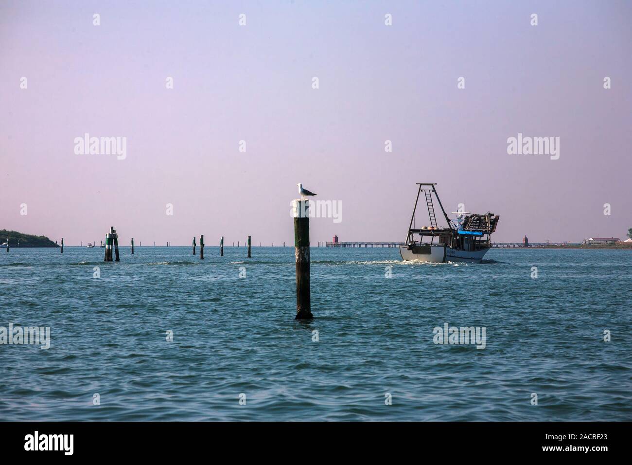 Fishing boat in the Marano Lagunare channed of the Laguna di Marano, Friuli-Venezia Giulia, Italy Stock Photo