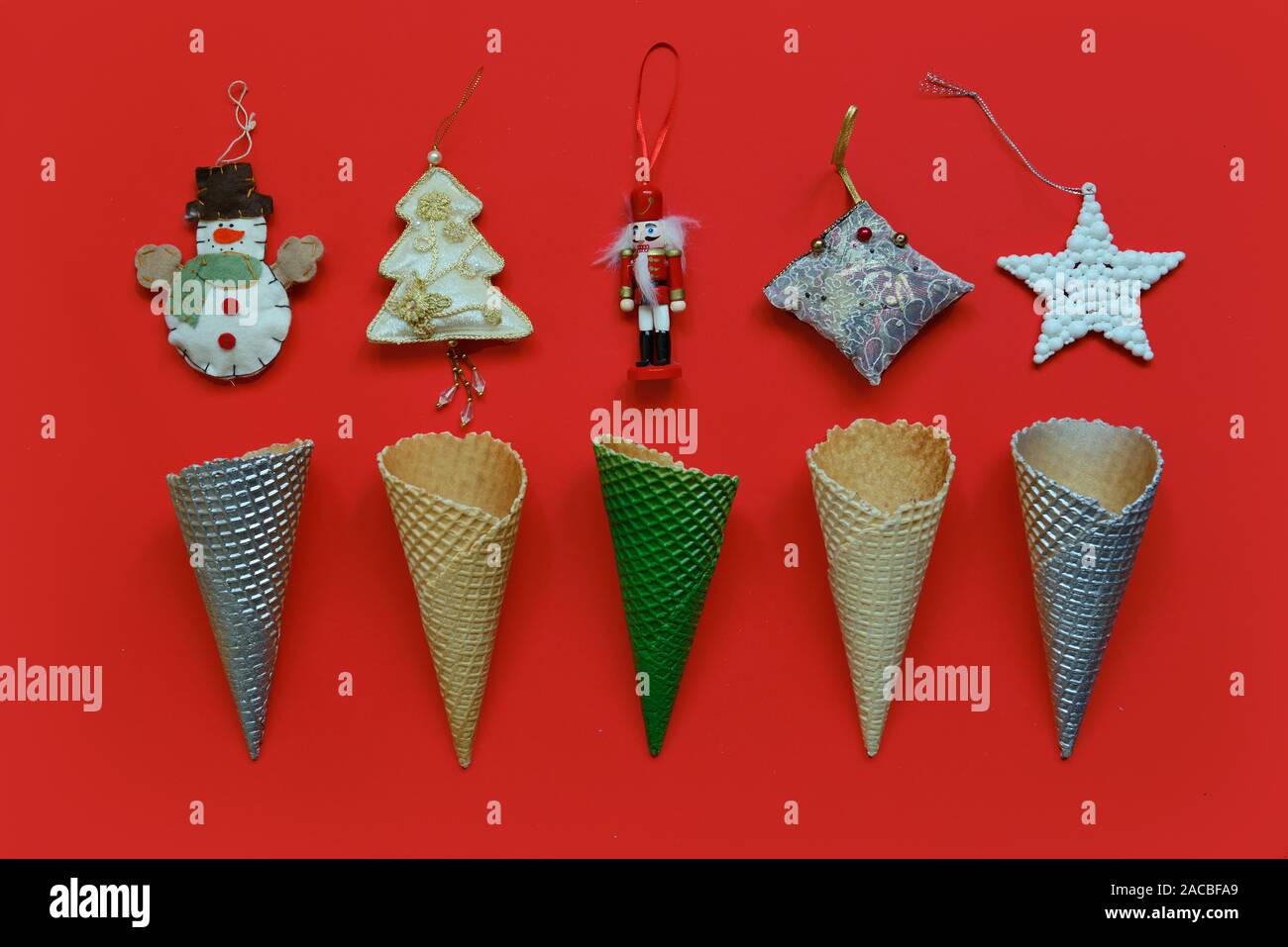 Trendy Christmas pattern made with ice creme cones decoration on red background. Christmas concept. Stock Photo