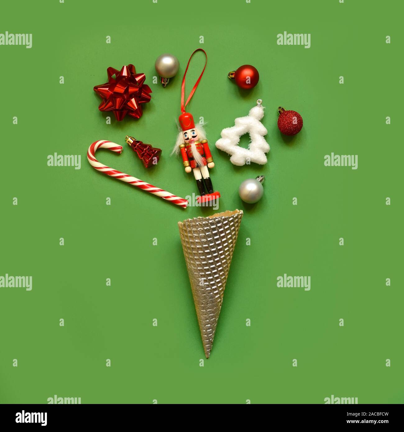 Trendy Christmas pattern made with creme cones ,candy,toys green on background. Minimal Christmas concept. Stock Photo