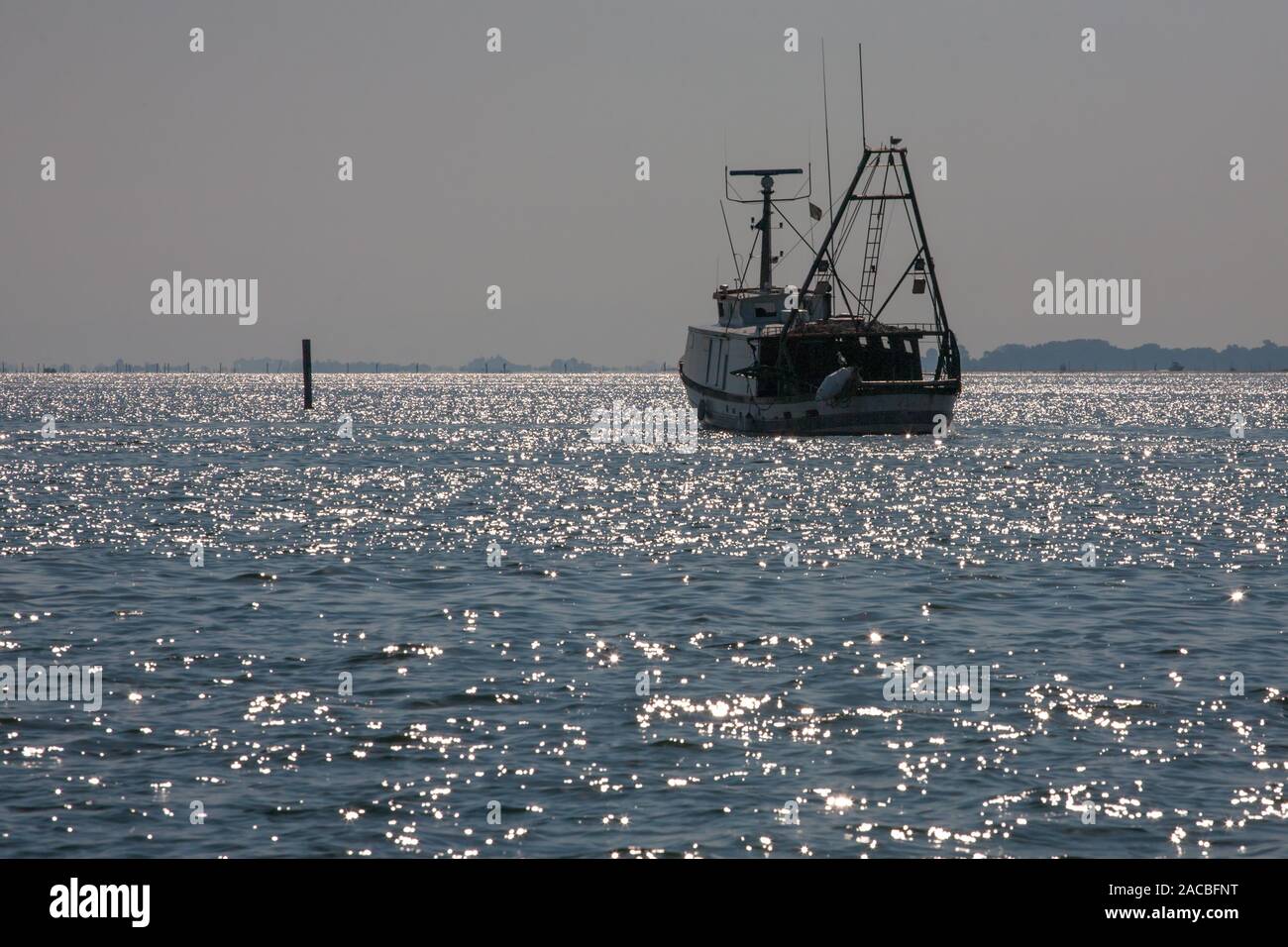 Fishing boat in the Marano Lagunare channel of the Laguna di Marano, Friuli-Venezia Giulia, Italy Stock Photo
