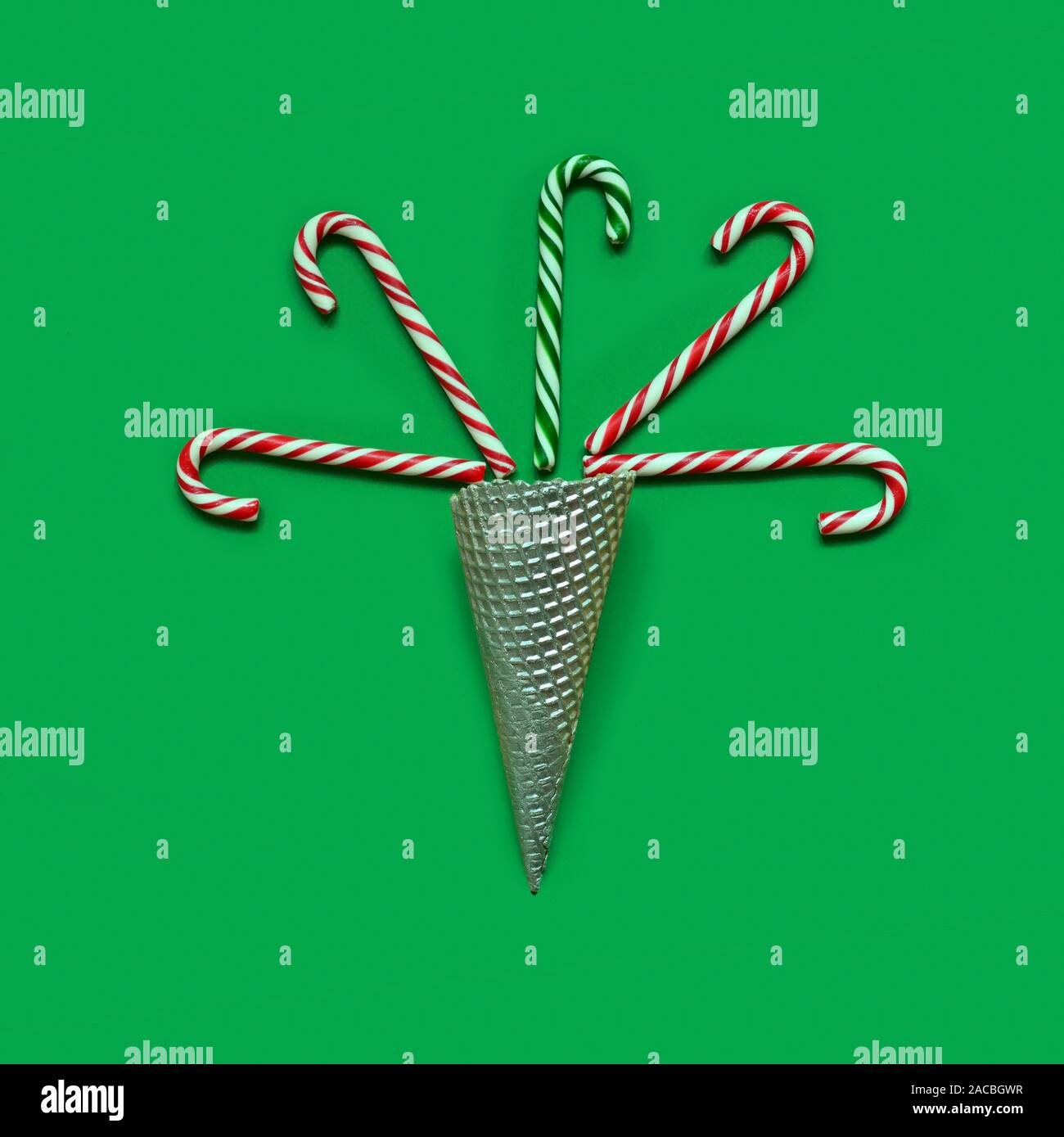 Creative minimal Christmas art. Pattern made with Christmas candies on green background Stock Photo