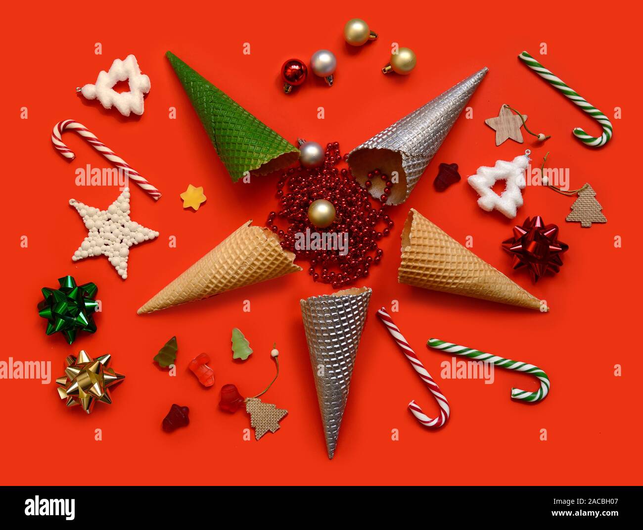 Conceptual Christmas still life.Christmas pattern made with creme cones ,candy, tree snowflake,bauble decoration on background Stock Photo
