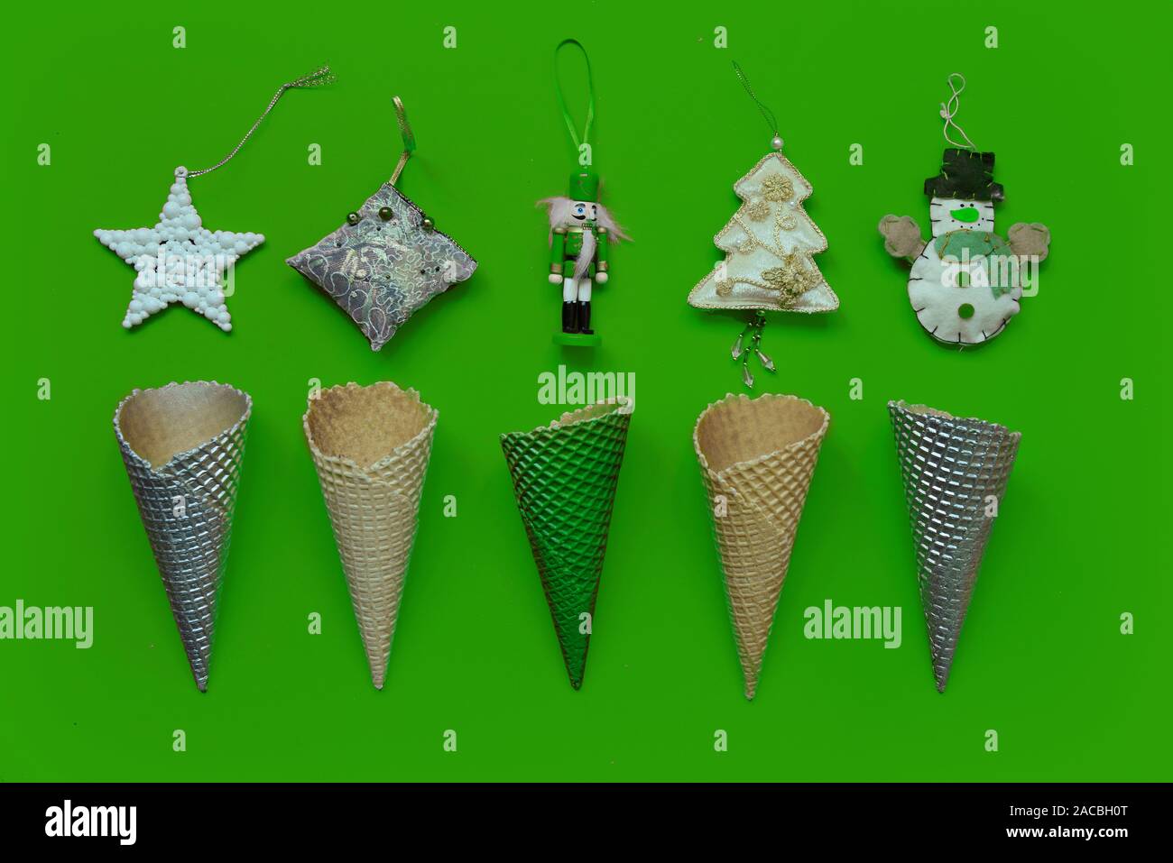 Trendy Christmas pattern made with ice creme cones decoration on geen background. Christmas concept. Stock Photo
