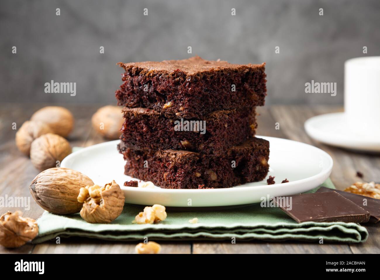 Chocolate brownie cakes with walnuts on a stack on a rustic wooden table Stock Photo