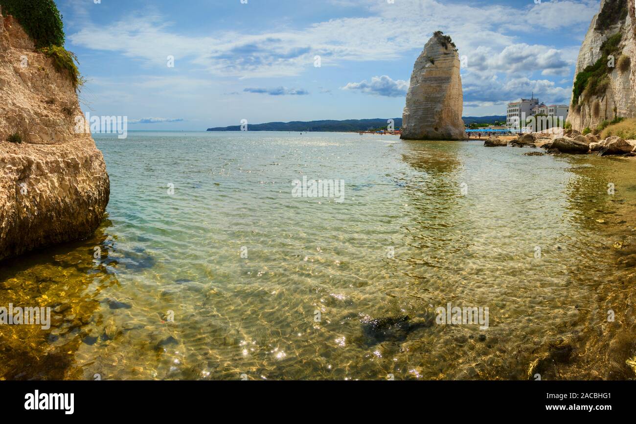 Gargano coast: bay of Vieste,(Apulia) ITALY.Castello or Scialara beach:it is overshadowed by the Swabiam Castle and the Pizzomunno Monolith . Stock Photo