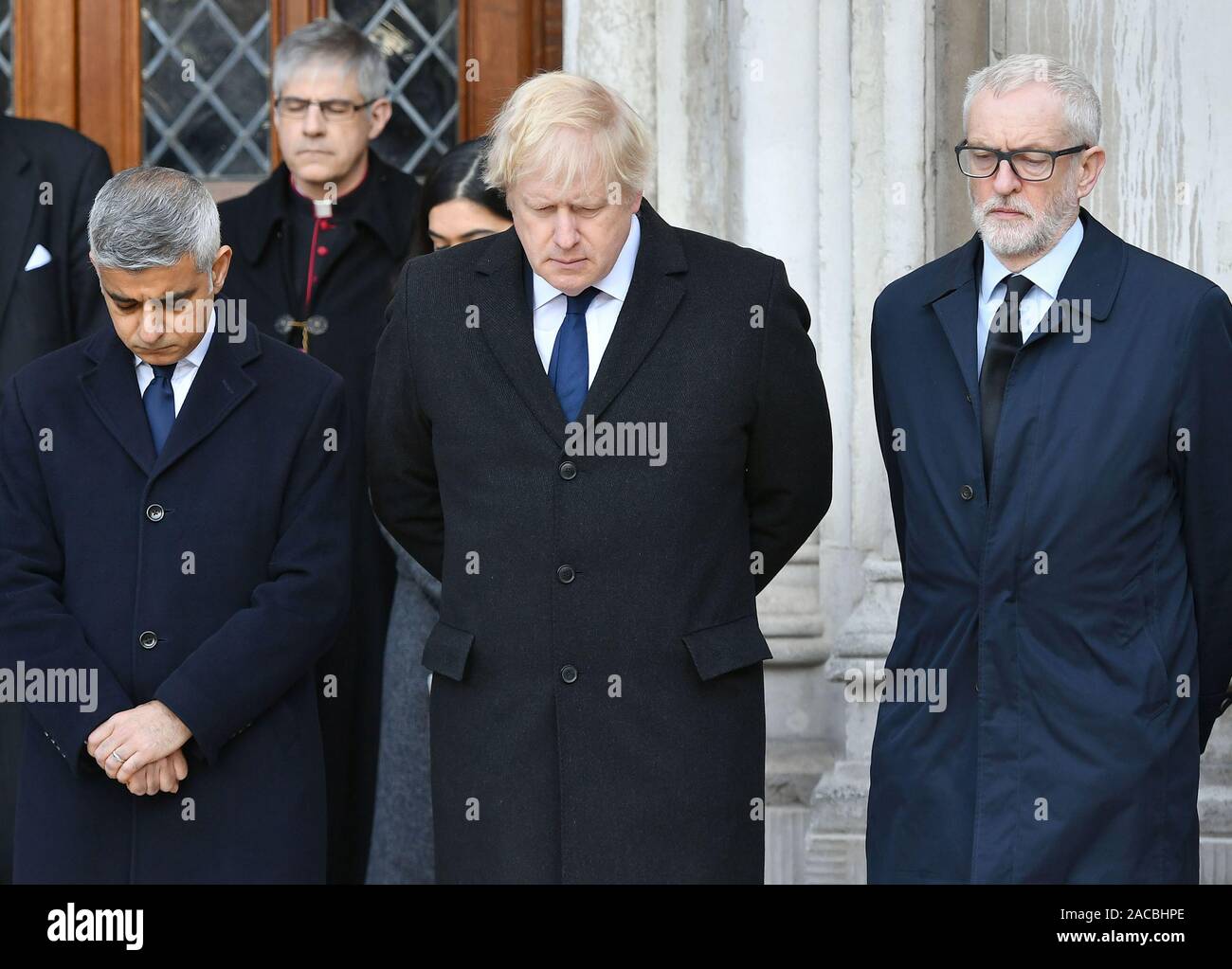 (left to right) Mayor of London Sadiq Khan, Prime Minister Boris Johnson and Labour leader Jeremy Corbyn take part in a vigil in Guildhall Yard, London, to honour the victims off the London Bridge terror attack, as well as the members of the public and emergency services who risked their lives to help others after a terrorist wearing a fake suicide vest went on a knife rampage killing two people, was shot dead by police on Friday. Stock Photo