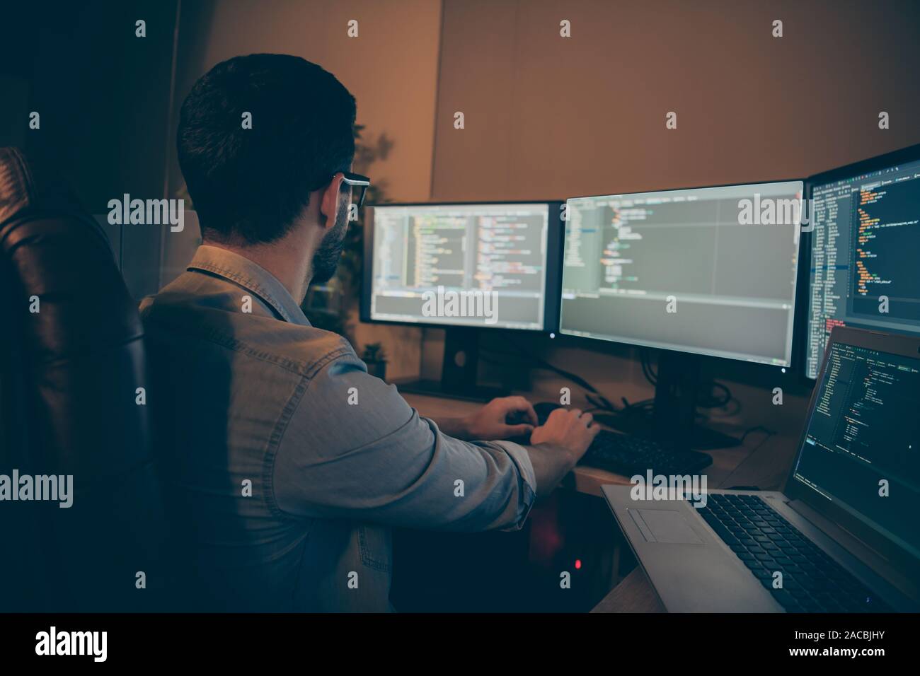 Profile side view of nice senior devops qualified expert focused brunette guy writing source solving tech problem checking database making report in Stock Photo