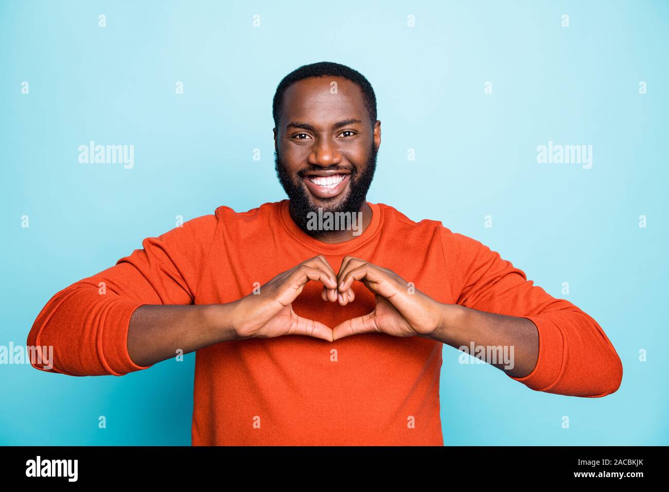 Photo Of Amazing Dark Skin Guy Holding Hands In Heart Figure