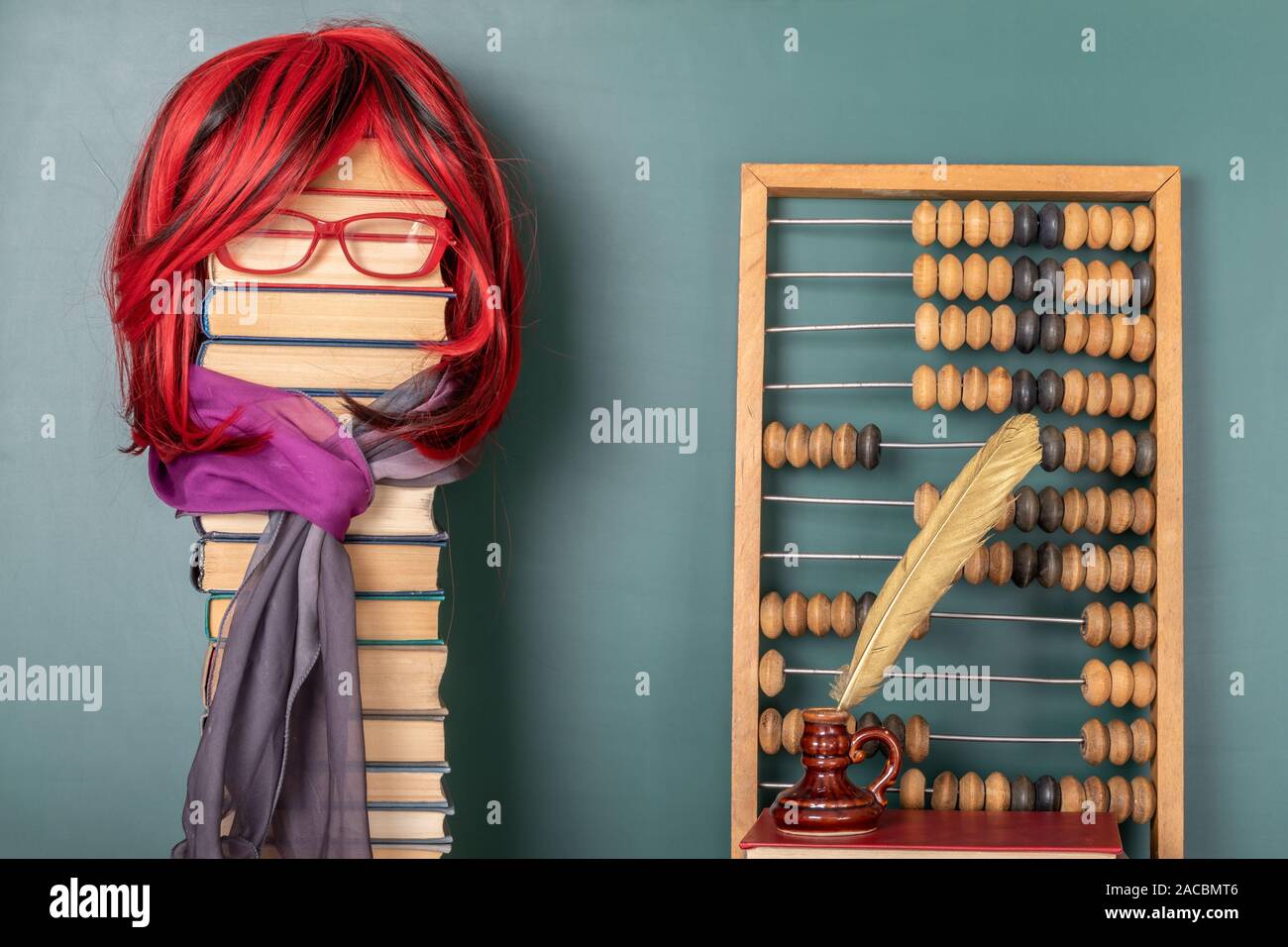 Funny education concept with beautiful teacher with luxurious red hair teaching arithmetic with the help of abacus. Stock Photo