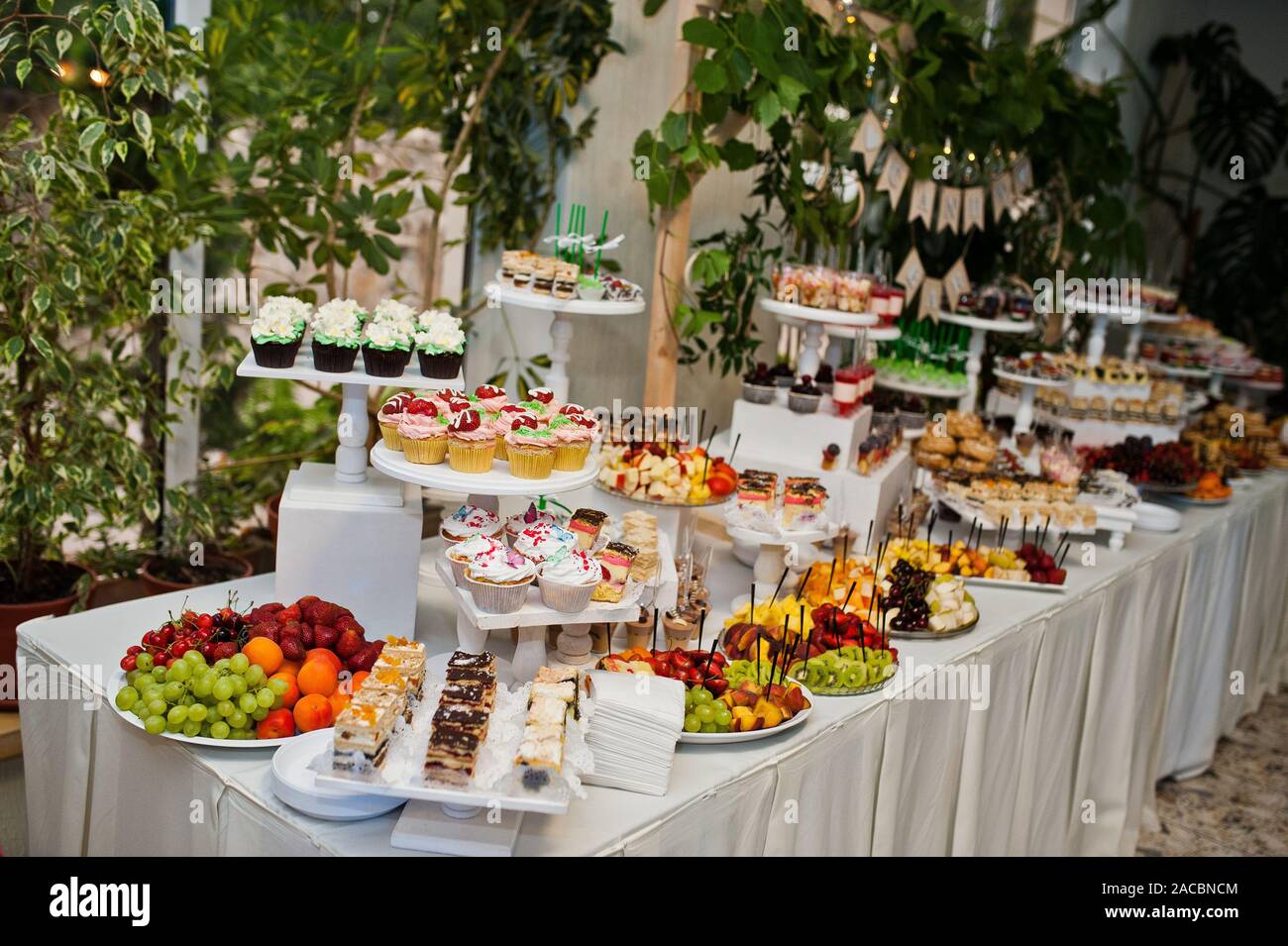 Dessert Table Of Delicious Sweets On Wedding Reception Stock Photo