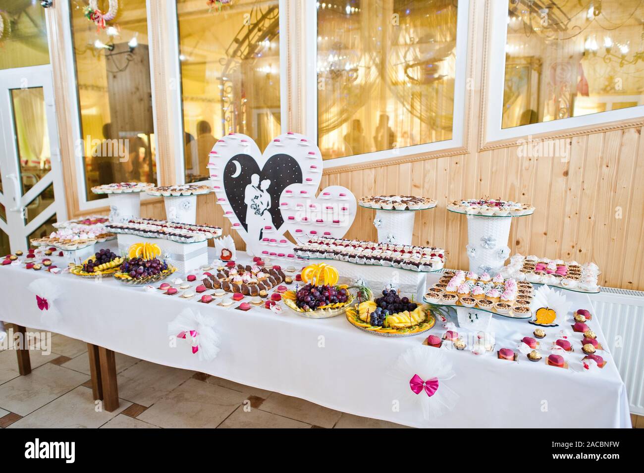Dessert Table Of Delicious Sweets On Wedding Reception Stock Photo
