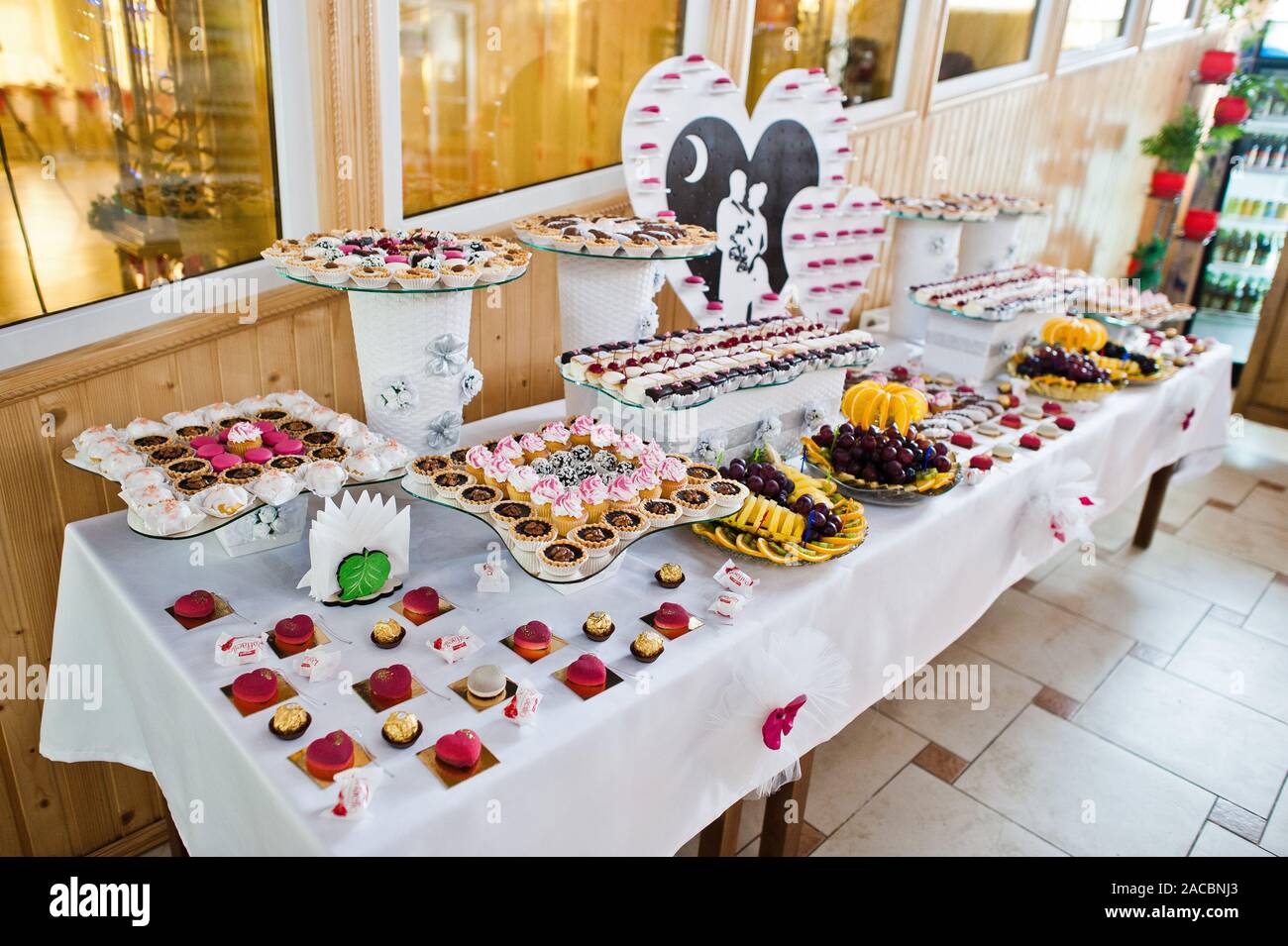 Dessert Table Of Delicious Sweets On Wedding Reception Stock Photo