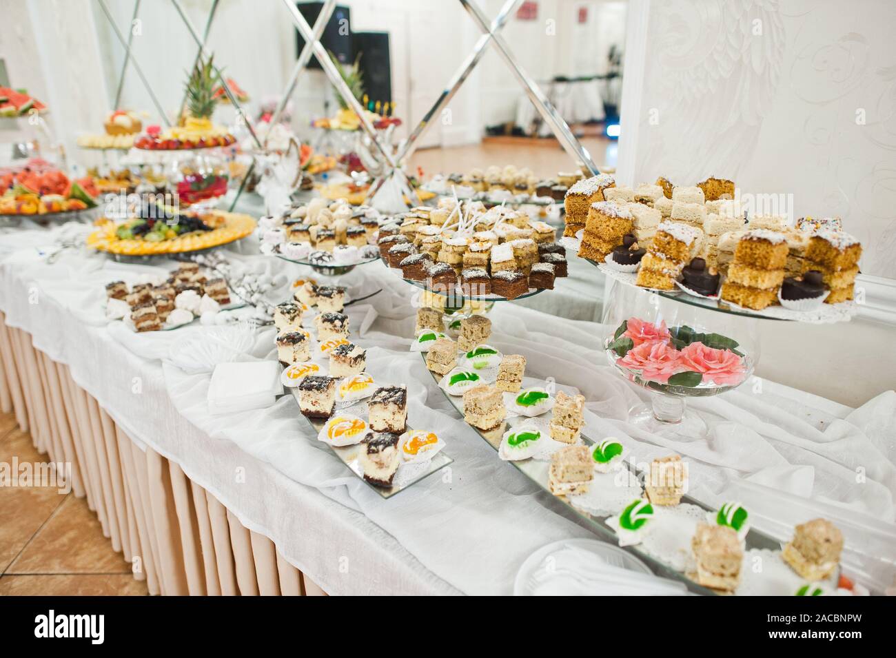 Dessert Table Of Delicious Sweets On Wedding Reception Stock Photo
