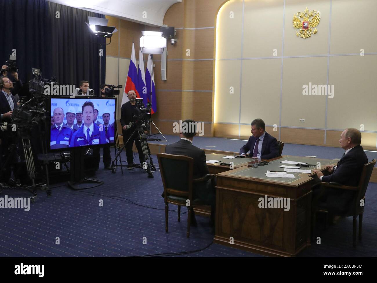 Moscow, Russia. 02nd Dec, 2019. Russian President Vladimir Putin (1st R), Russian Energy Minister Alexander Novak (L) and Deputy Prime Minister Dmitry Kozak (2nd R) watch the launching ceremony of the China-Russia east-route natural gas pipeline via teleconference in Sochi, Russia, Dec. 2, 2019. Chinese President Xi Jinping had a video call with his Russian counterpart Vladimir Putin Monday afternoon, as the two heads of state jointly witnessed the launching ceremony of the China-Russia east-route natural gas pipeline. (Sputnik/Handout via Xinhua) Credit: Xinhua/Alamy Live News Stock Photo