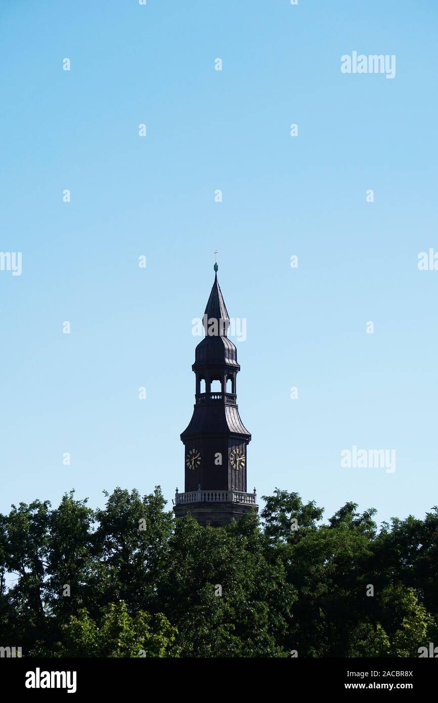 church tower above treetops Stock Photo