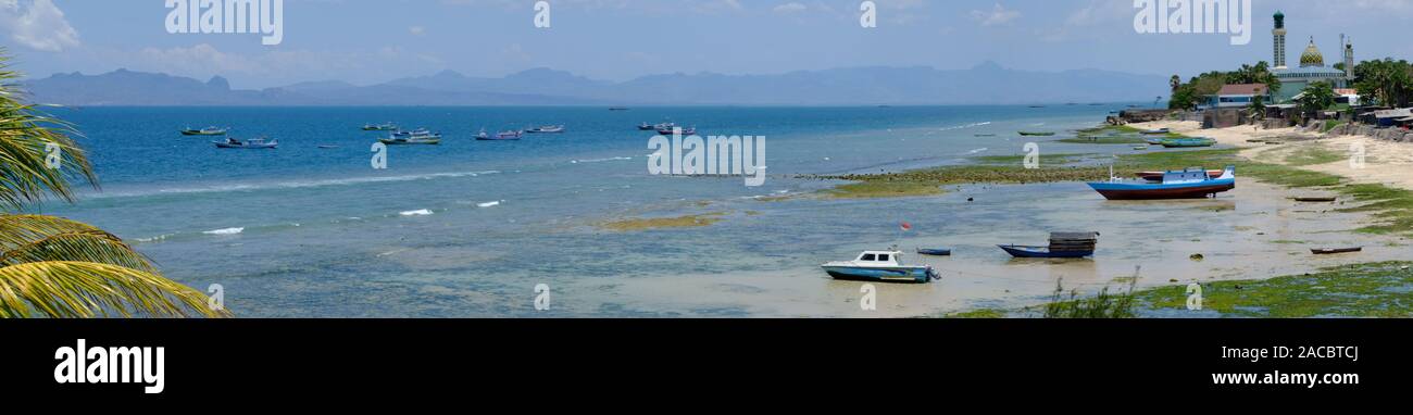Indonesia Kupang city Coastline with fishing boats and mosque Nurul Hidayah - panoramic photo Stock Photo