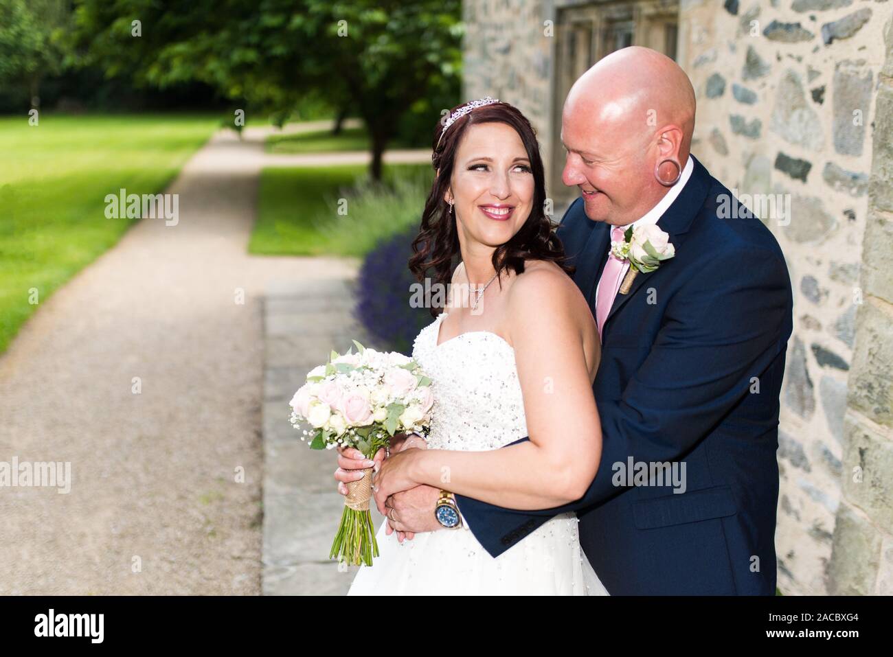 A bride and groom smiling, laughing together happy and in love on their wedding day, wedding photography Stock Photo
